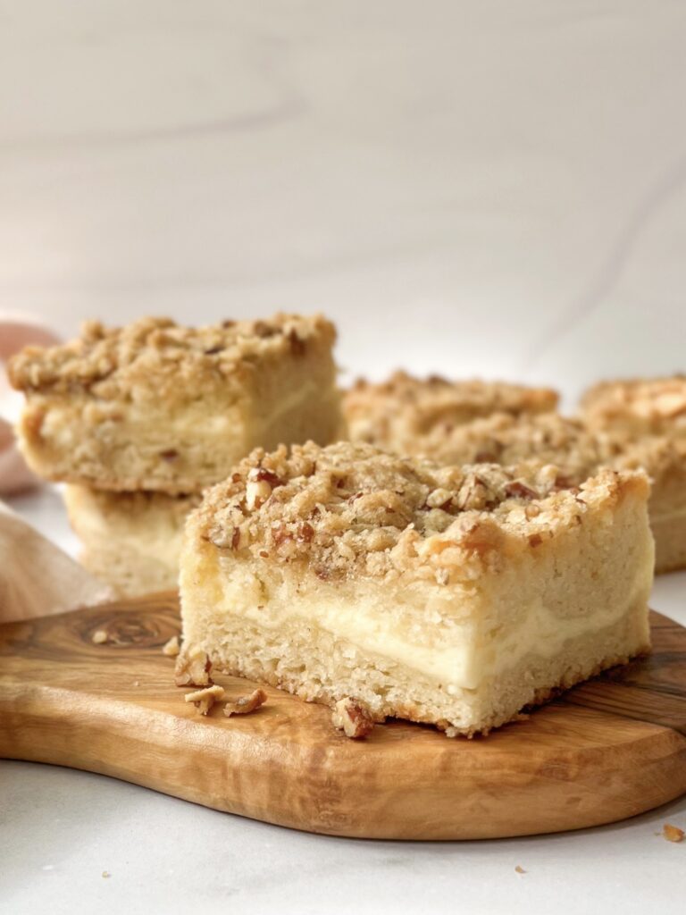 Polish Cream Cheese Coffee Cake with layers of soft and butter cake and cream cheese topped with nut crumbs.